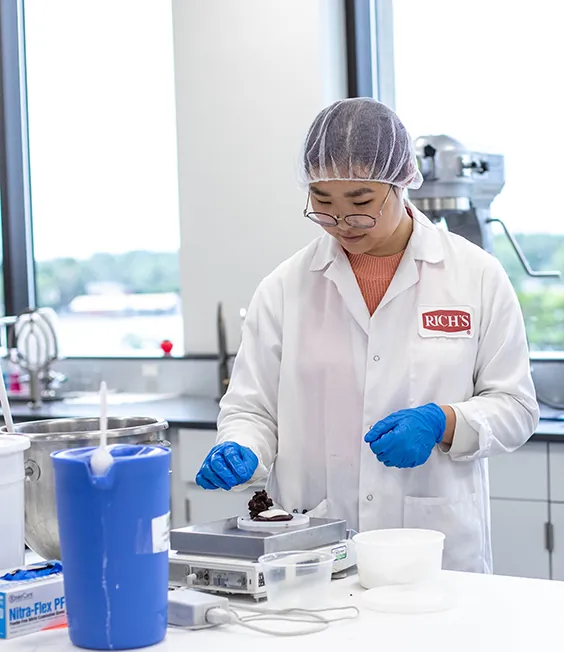 Rich's employee working in a food lab.