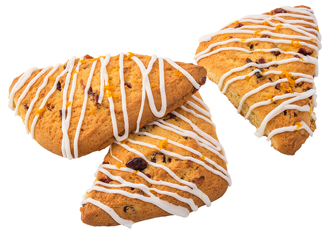 Three cranberry orange scones with drizzled icing.