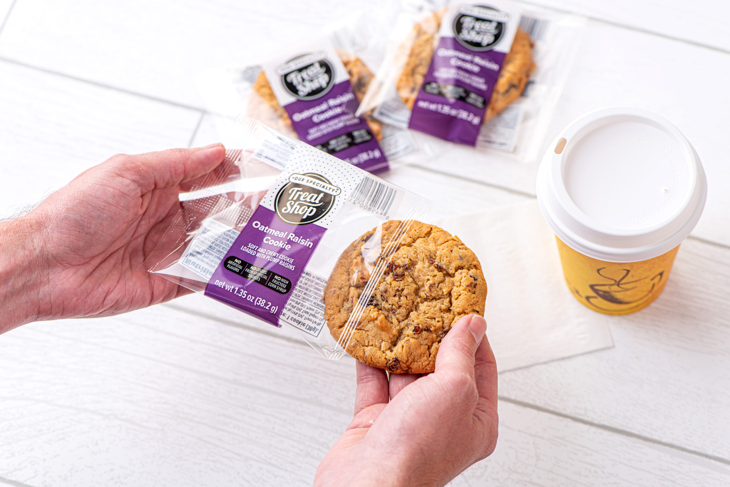 Individually wrapped cookie and to-go coffee cup.