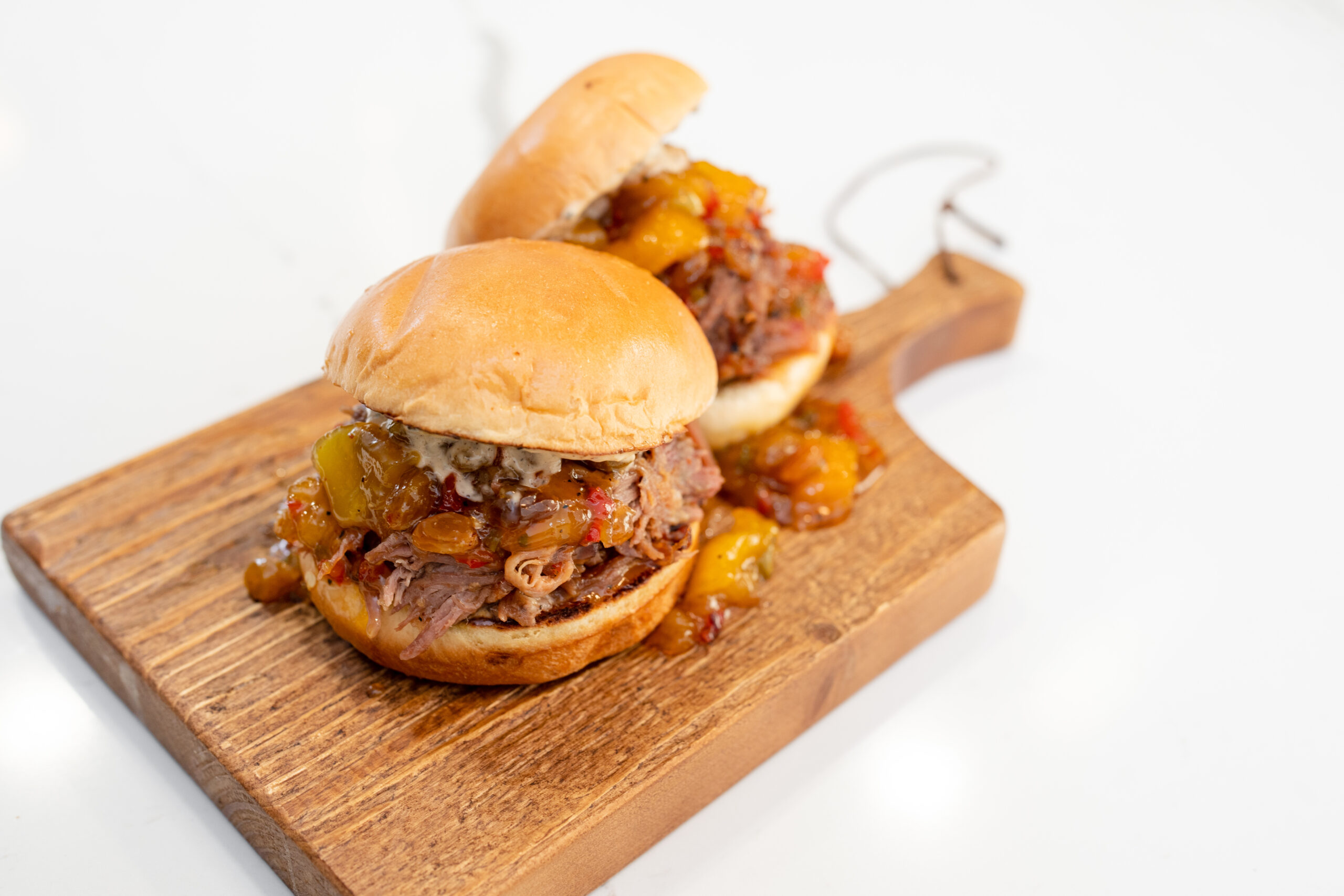 Pulled pork on a bun on a cutting board