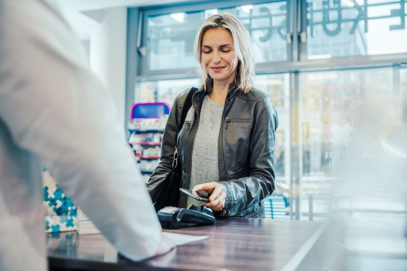 woman checking out using mobile pay