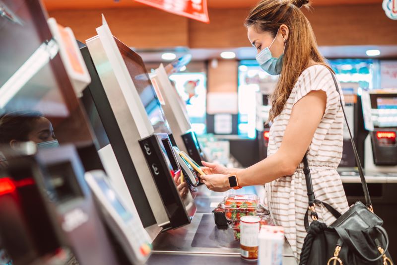 woman checking out at kiosk