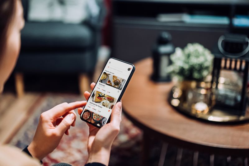 person looking at ordering food on mobile phone