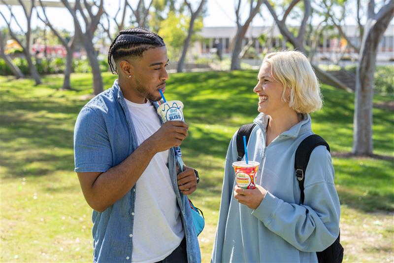two people sipping on milkshakes