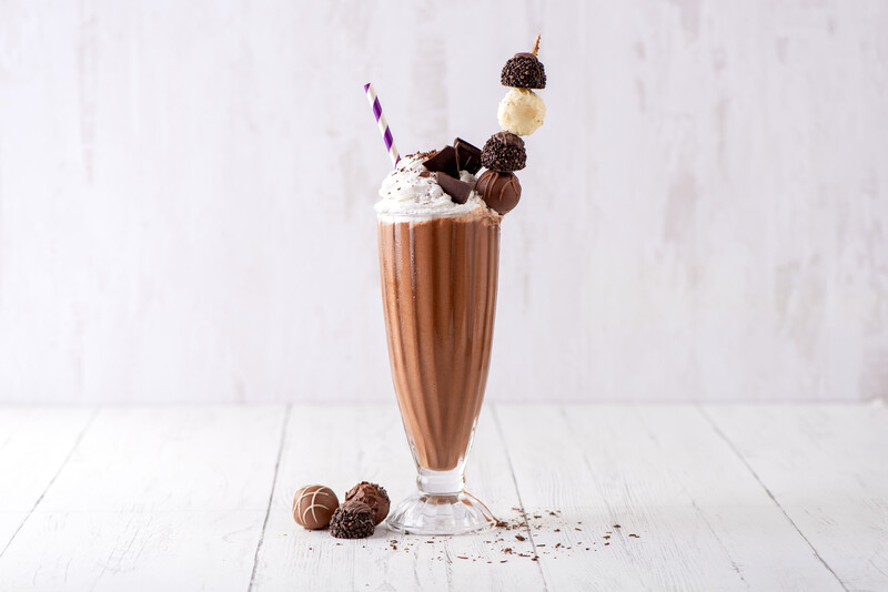 chocolate freakshake with on top oat milk whipped topping