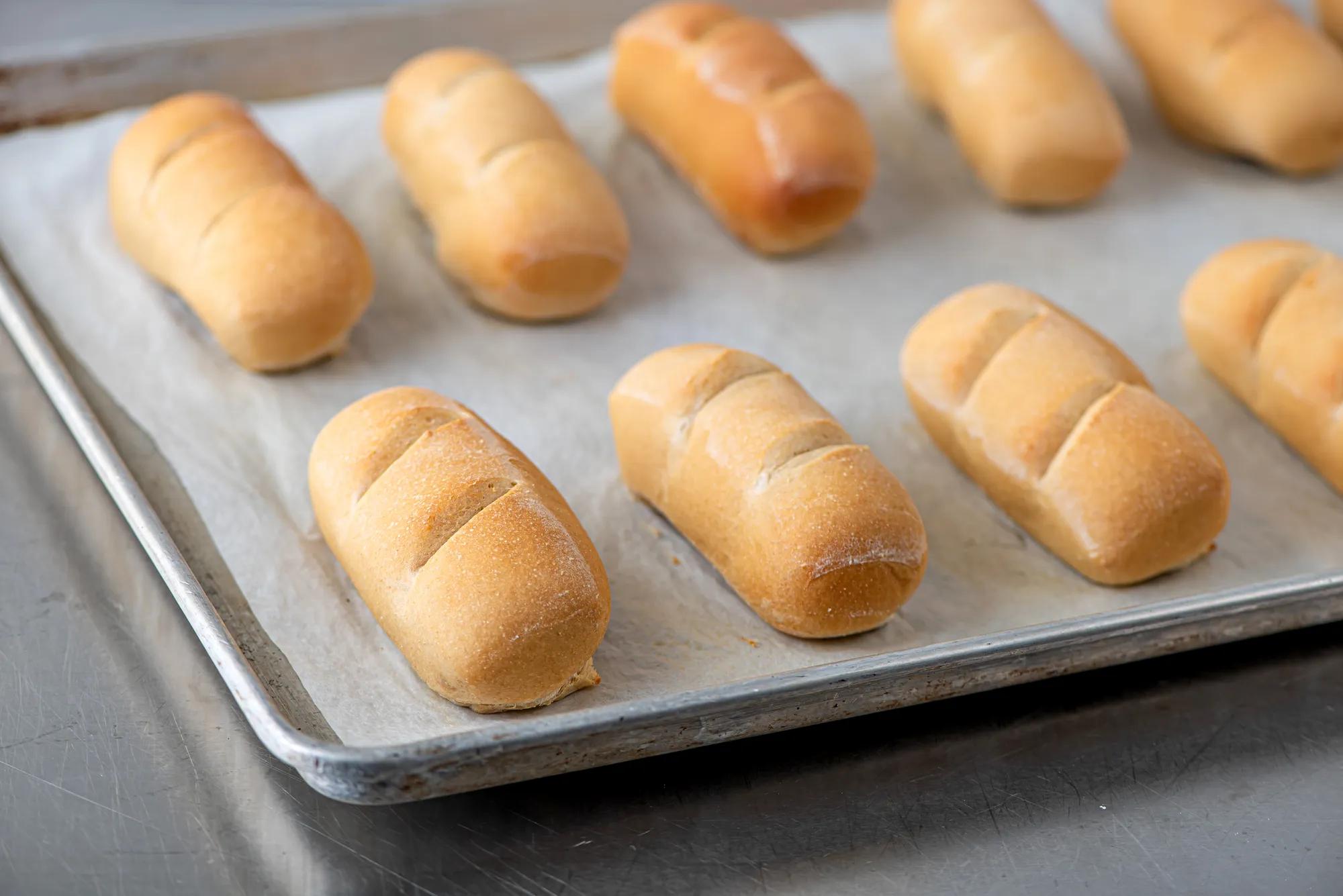 Mini bread loaves on a baking sheet