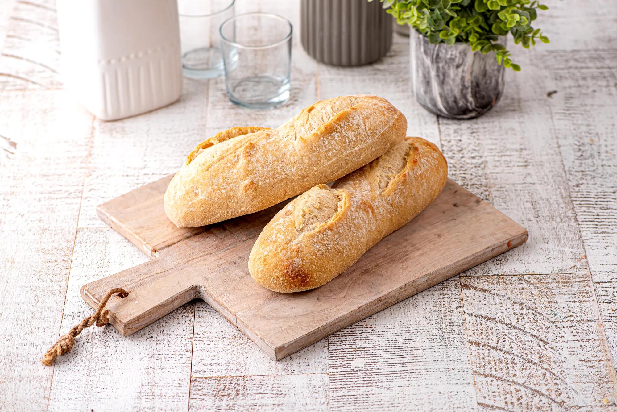 Two loaves of breads on a cutting board