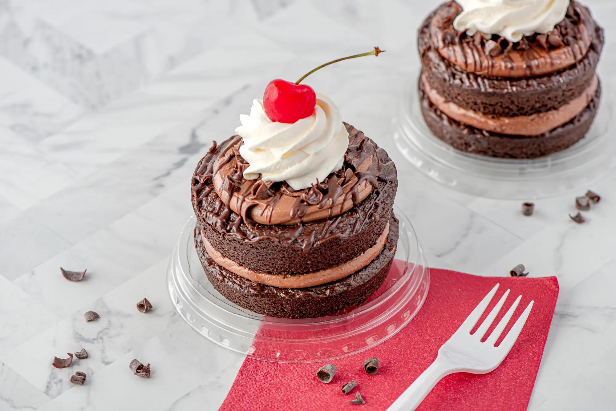 Mini chocolate layer cakes with whipped cream & cherry on top