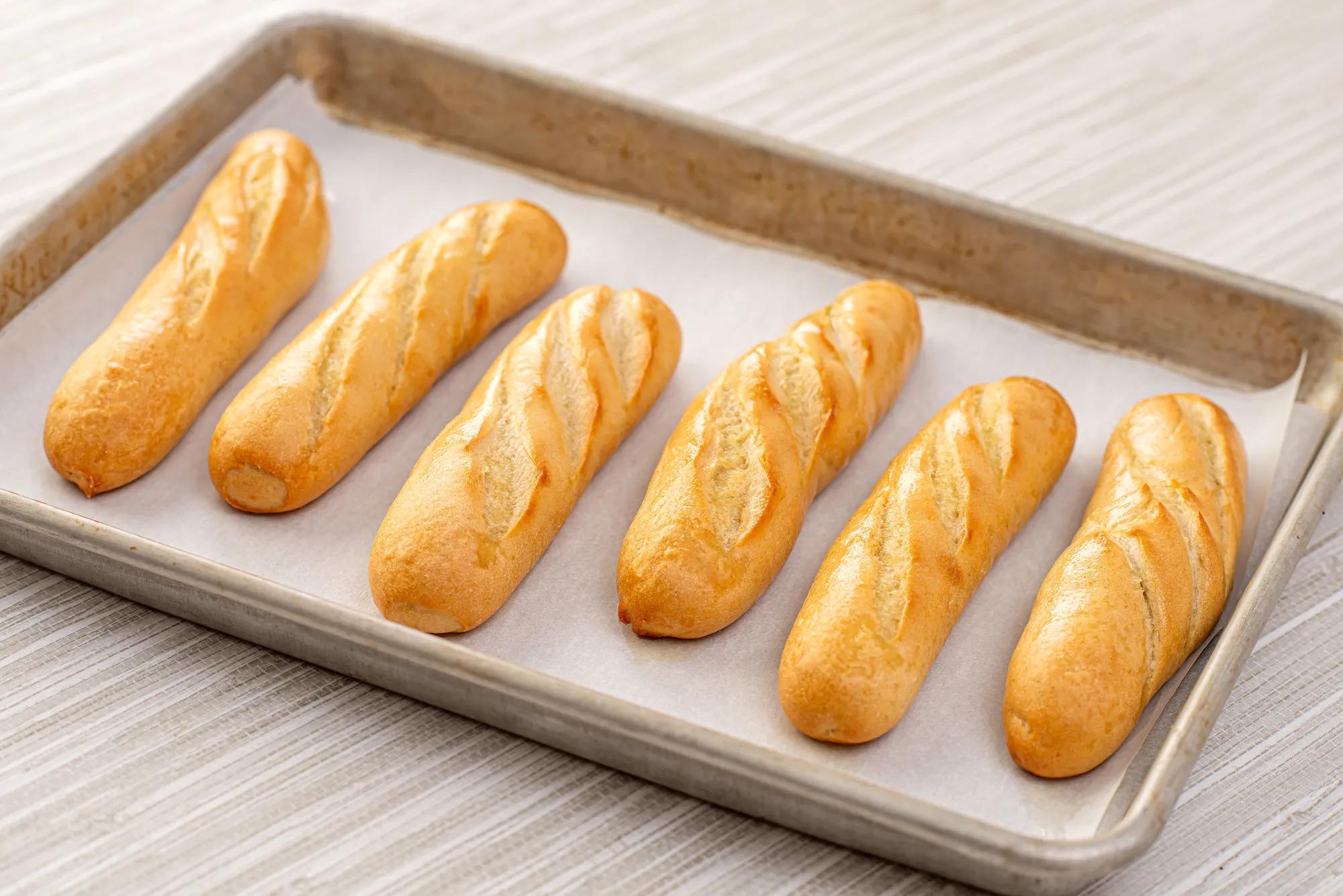 Mini baguettes on a baking sheet